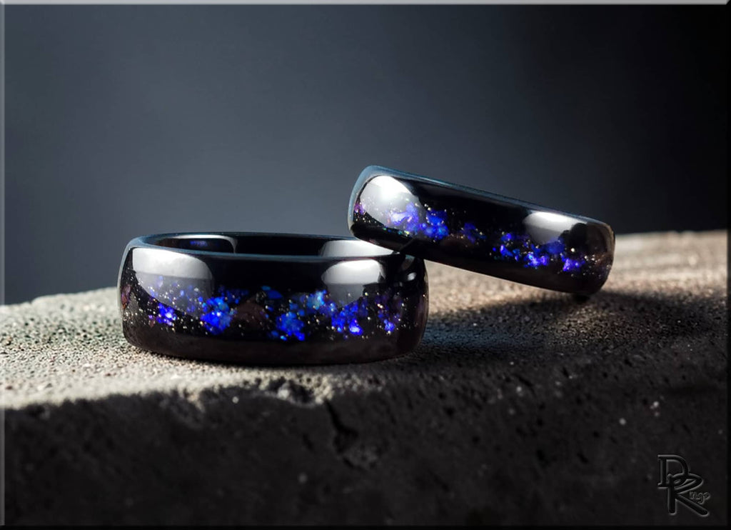 DR Rings polished black tungsten as a ring with blue galaxy pattern inlay on textured surface