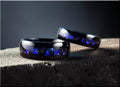 DR Rings polished black tungsten as a ring with blue galaxy pattern inlay on textured surface