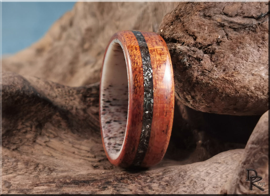 Wood ring with meteorite inlay on deer antler core by DR Rings displayed on natural wood background