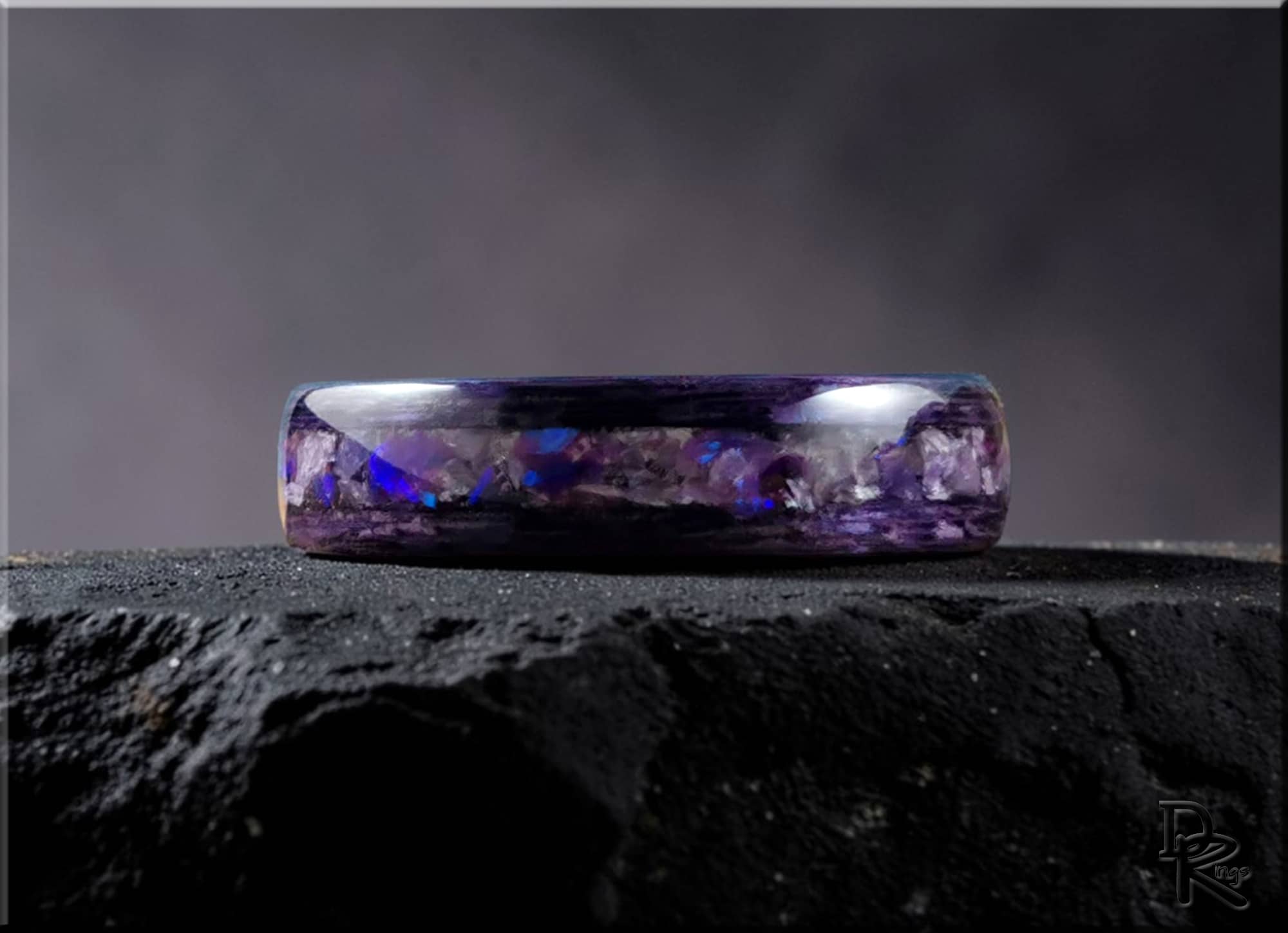 DR Rings wood ring with opal inlay featuring a purple iridescent design on a dark textured surface
