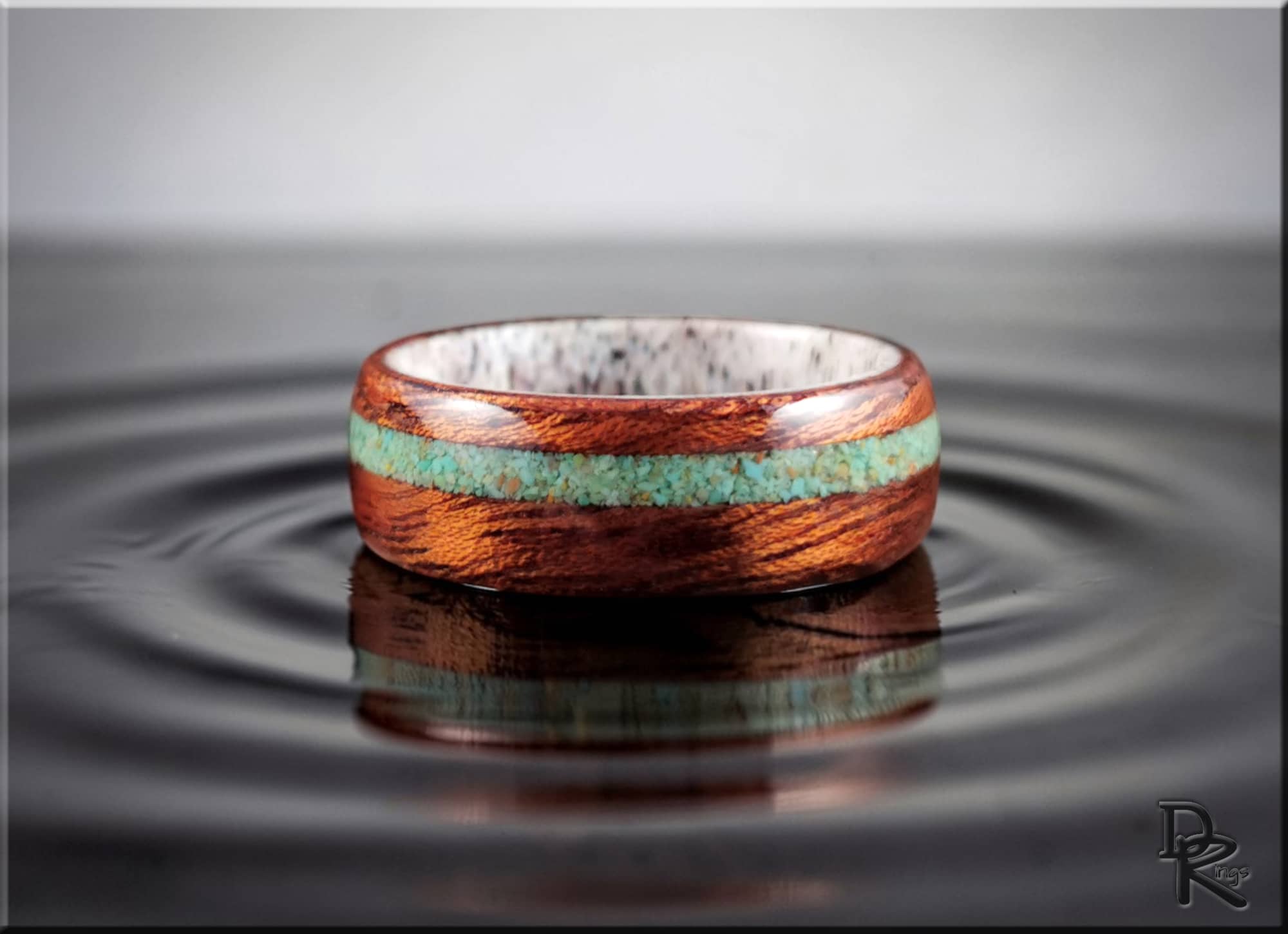 Wood ring with turquoise and antler featuring polished wooden band with turquoise inlay and white antler interior