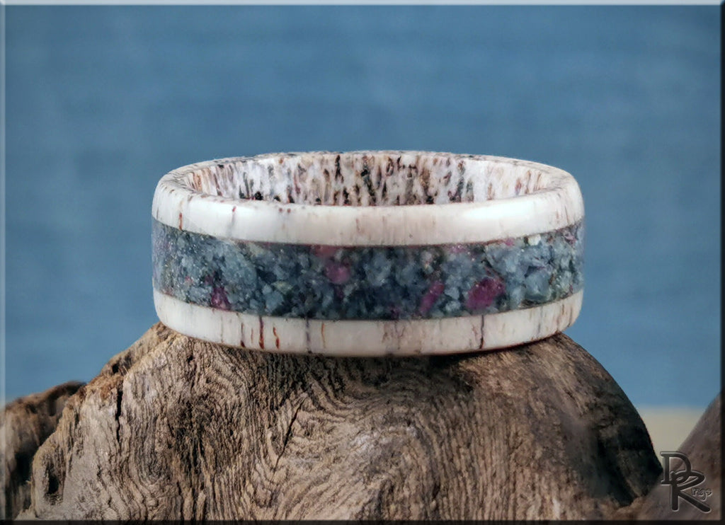 DR Rings unique antler ring with kyanite and ruby inlay on natural wood background