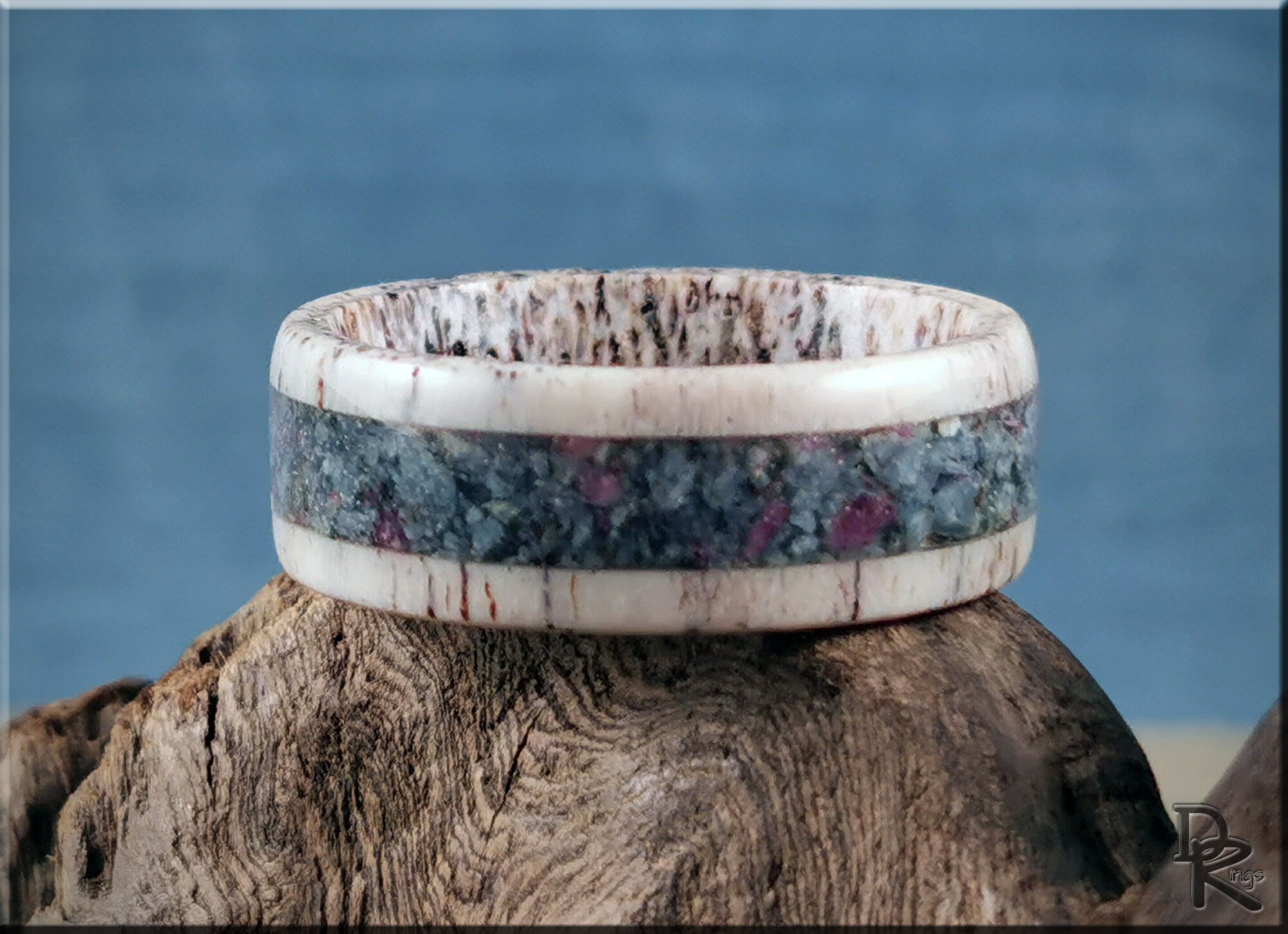 DR Rings unique antler ring with kyanite and ruby inlay on natural wood background