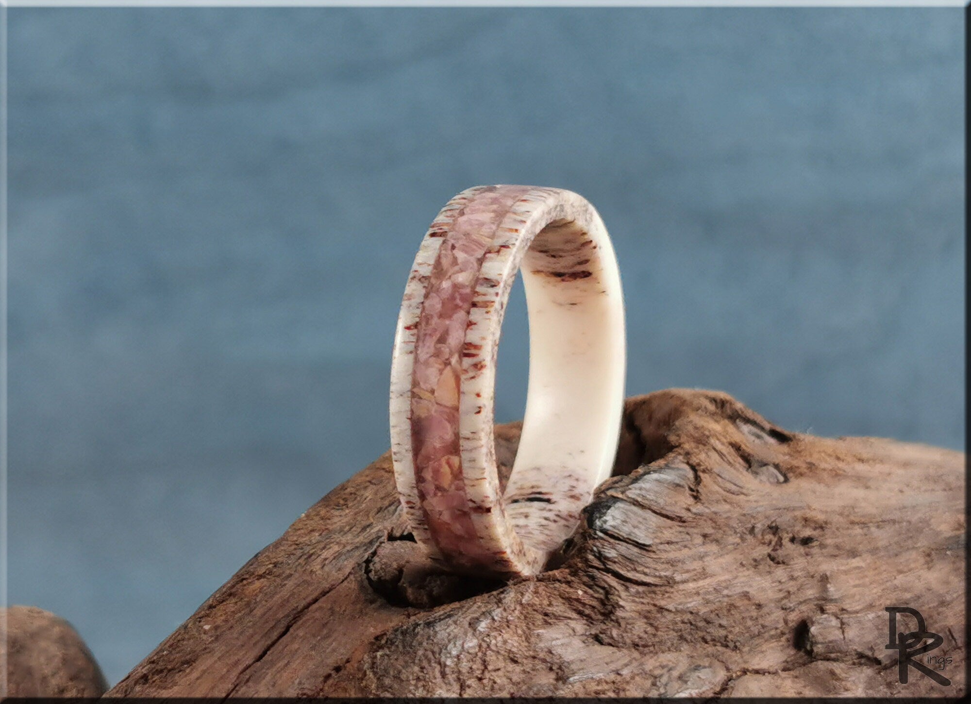 Antler Ring with stone inlay by DR Rings displayed on rustic wood with natural textured background