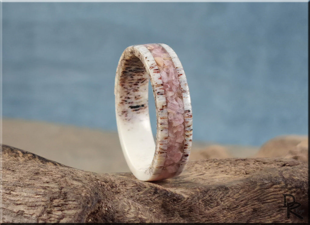 Antler Ring with stone inlay featuring pink stone and natural antler material on textured wood