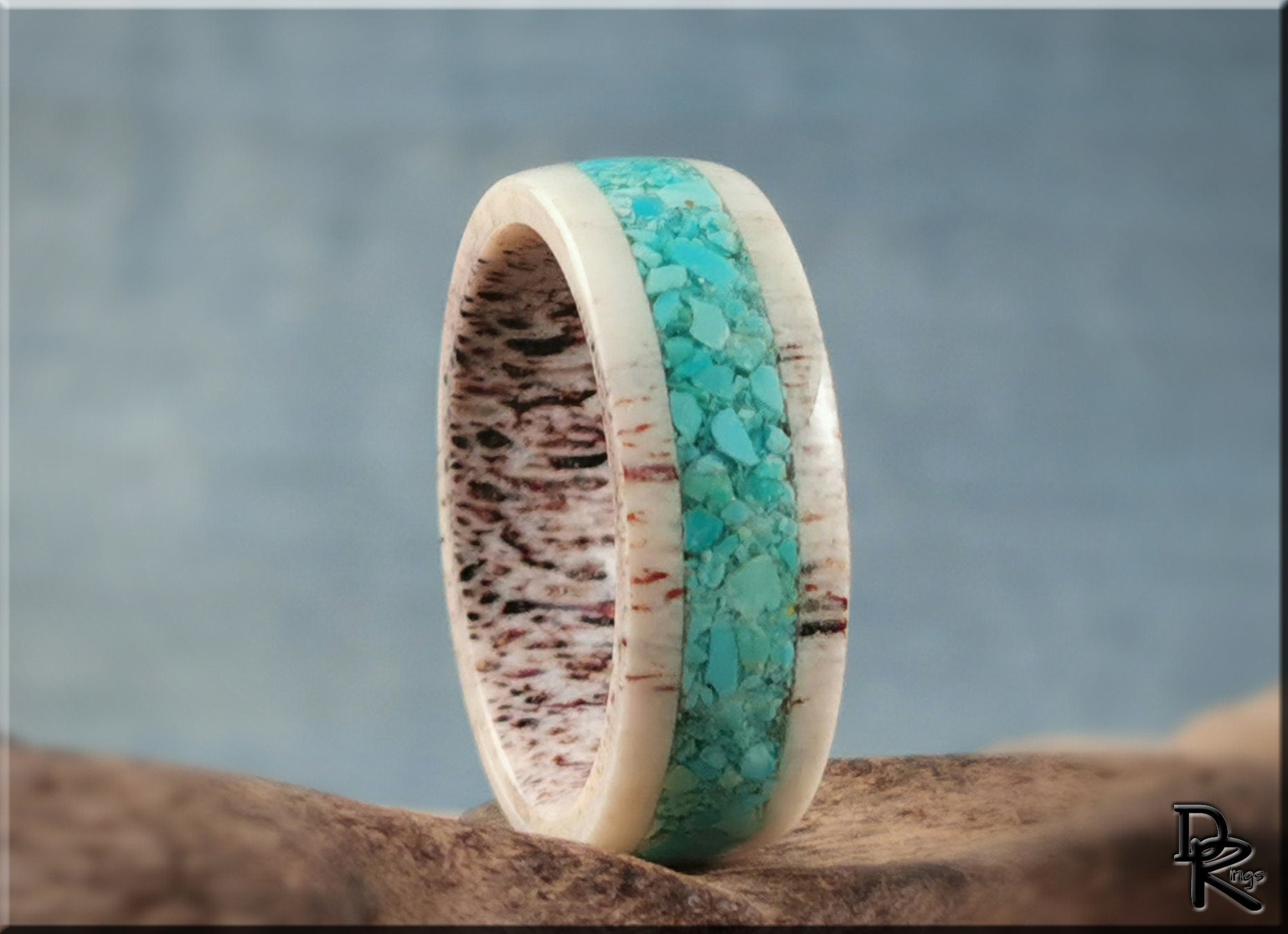 Antler ring with turquoise inlay featuring a textured natural antler band and vibrant turquoise center