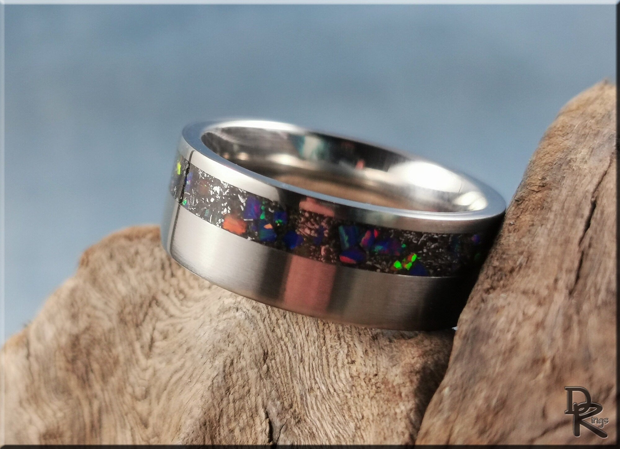 DR Rings titanium ring with meteorite featuring a shiny silver band and colorful inlay design