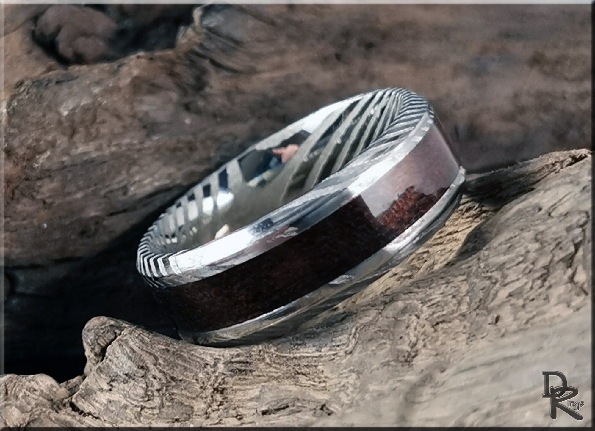 Damascus steel ring with wood inlay from DR Rings showcasing detailed metal pattern and smooth wood finish