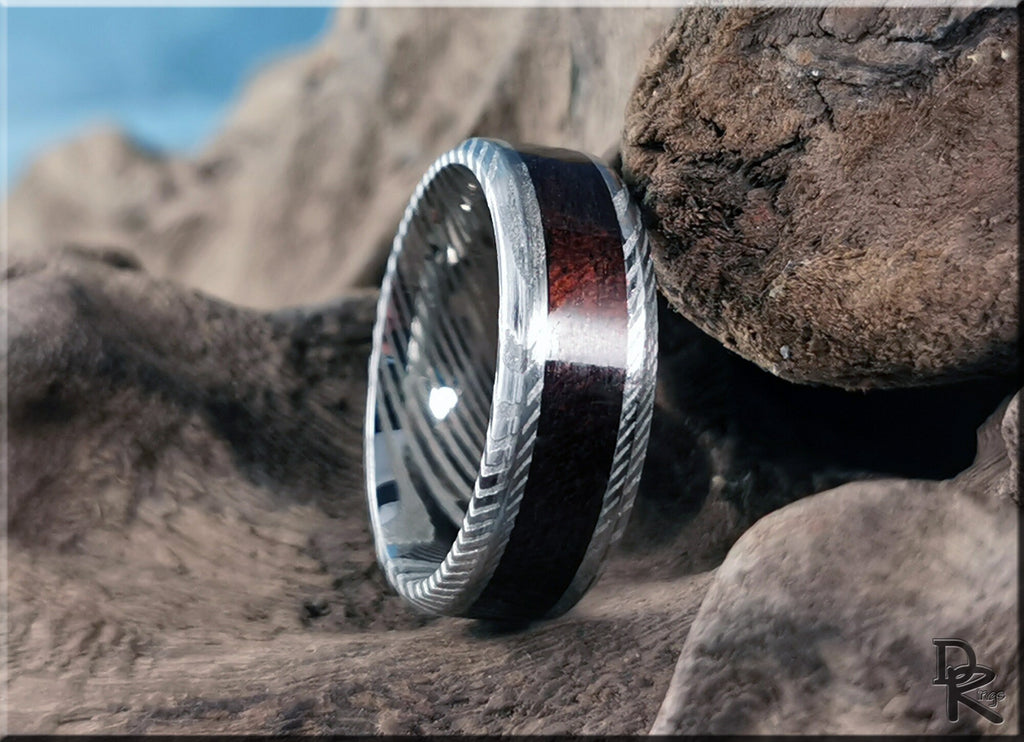 Damascus steel ring with wood inlay featuring intricate metal patterns and rich wood texture by DR Rings