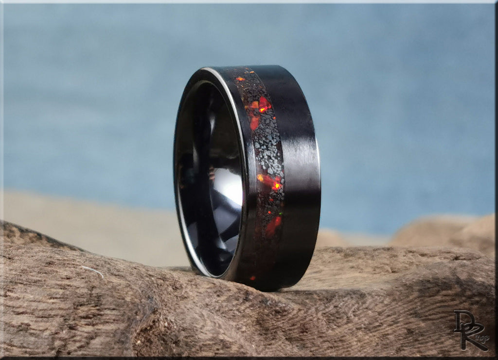 DR Rings black band ring opal with red and orange opal inlay on textured wood background