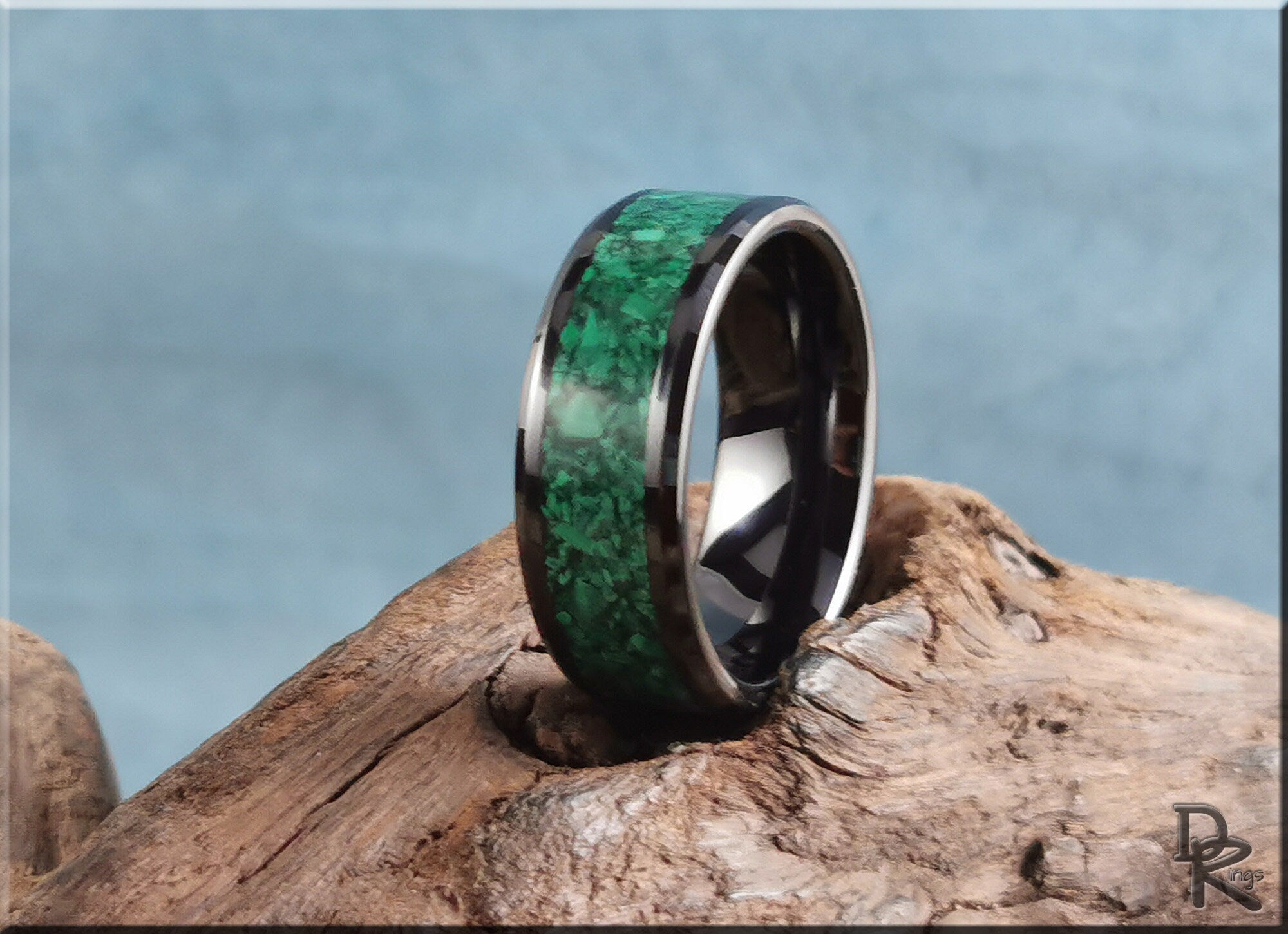DR Rings black ceramic ring with green stone inlay displayed on rustic wood surface