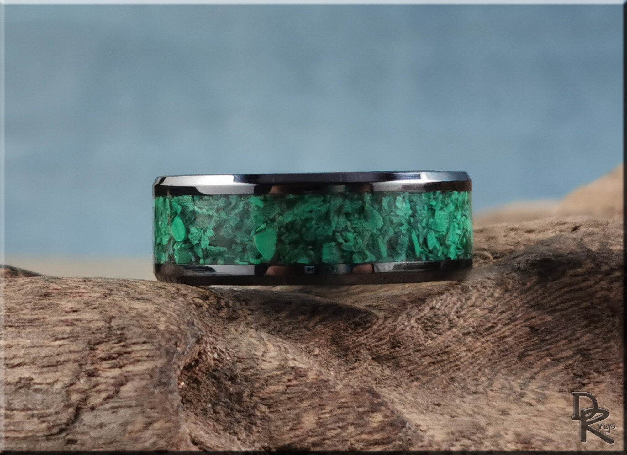 DR Rings black ceramic ring with green stone inlay design on rustic wood surface