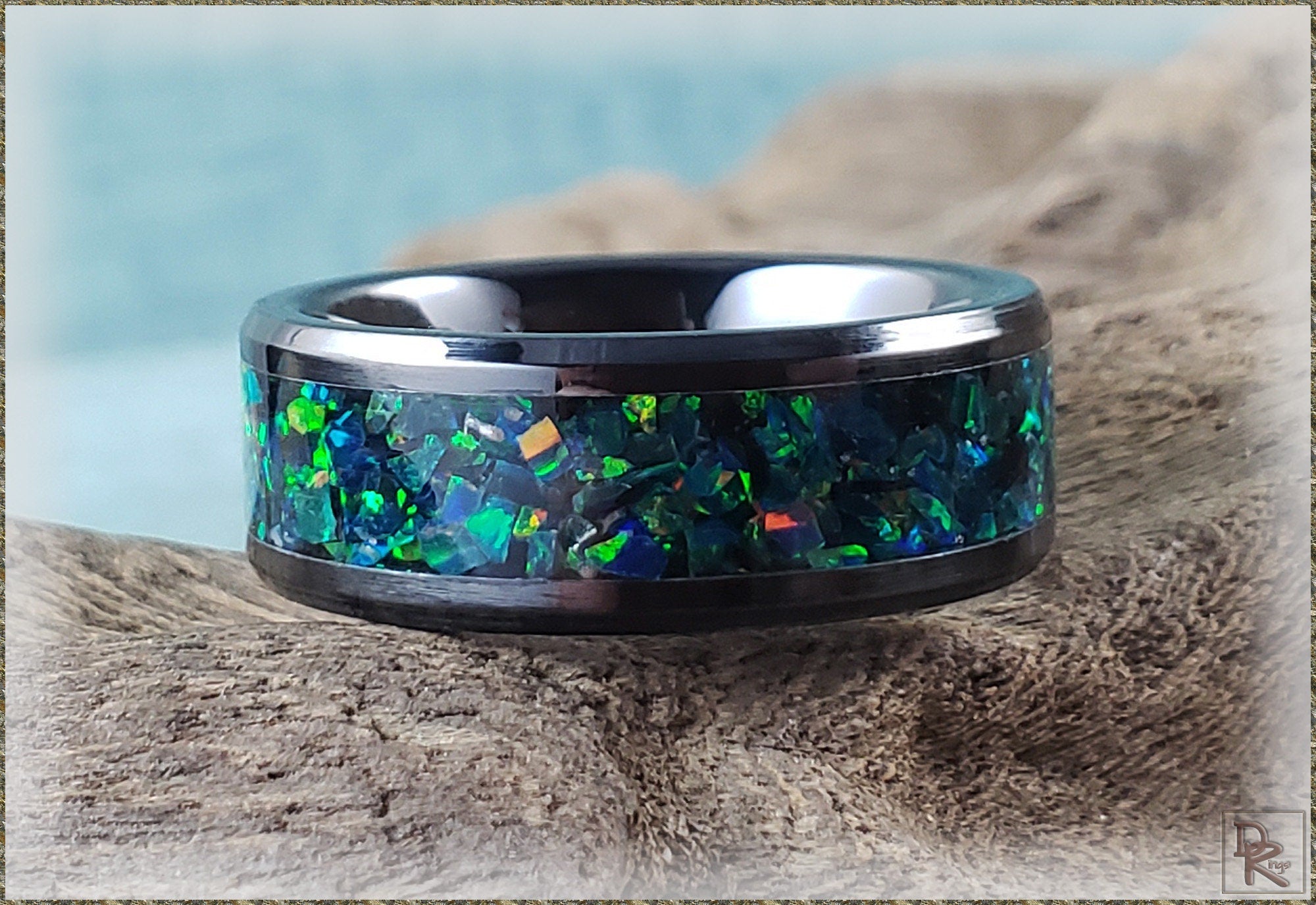 DR Rings ceramic ring with iridescent blue and green inlay on a black band