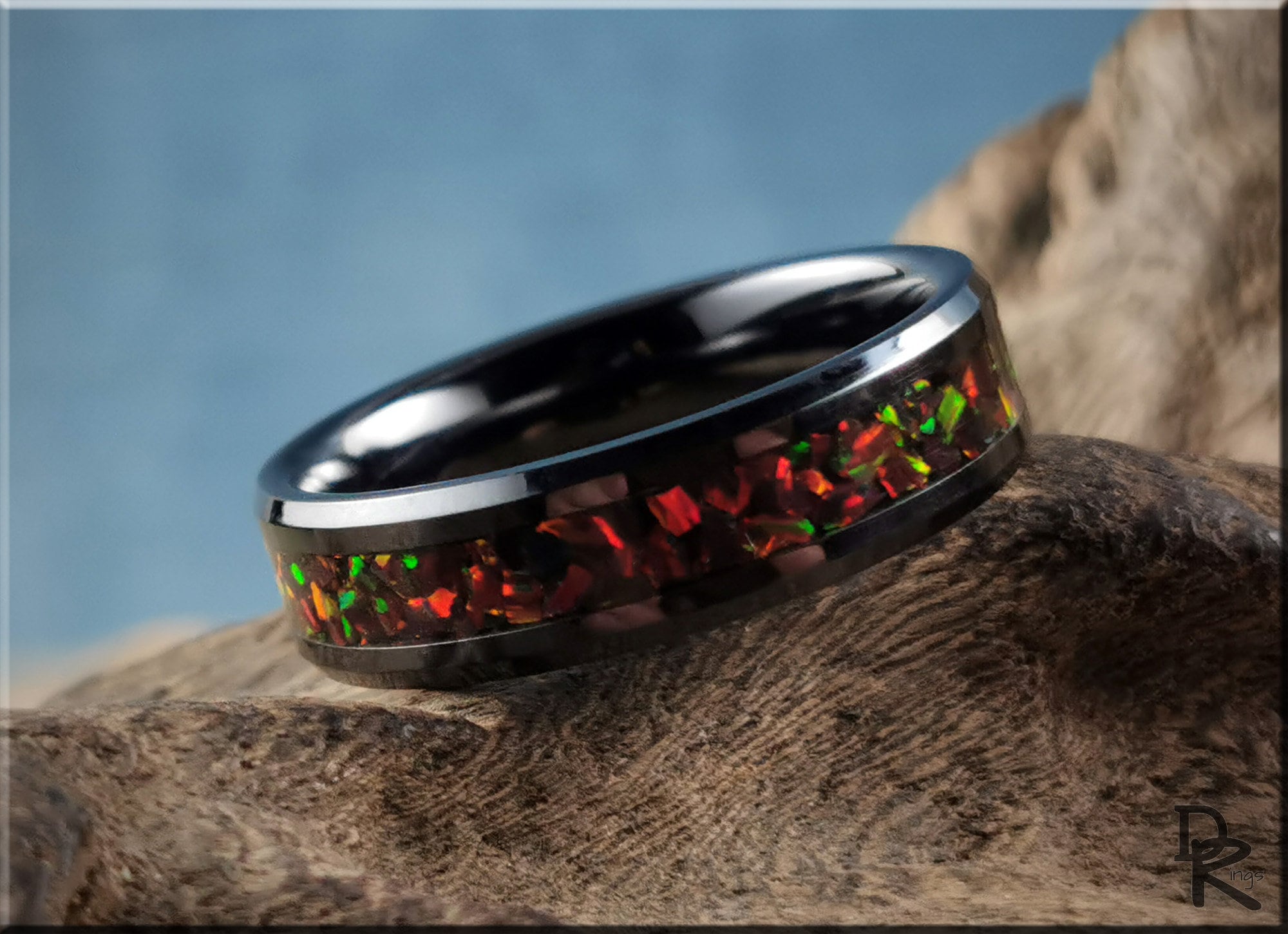 DR Rings ceramic ring with inlay featuring vibrant red and green opal design on a black band