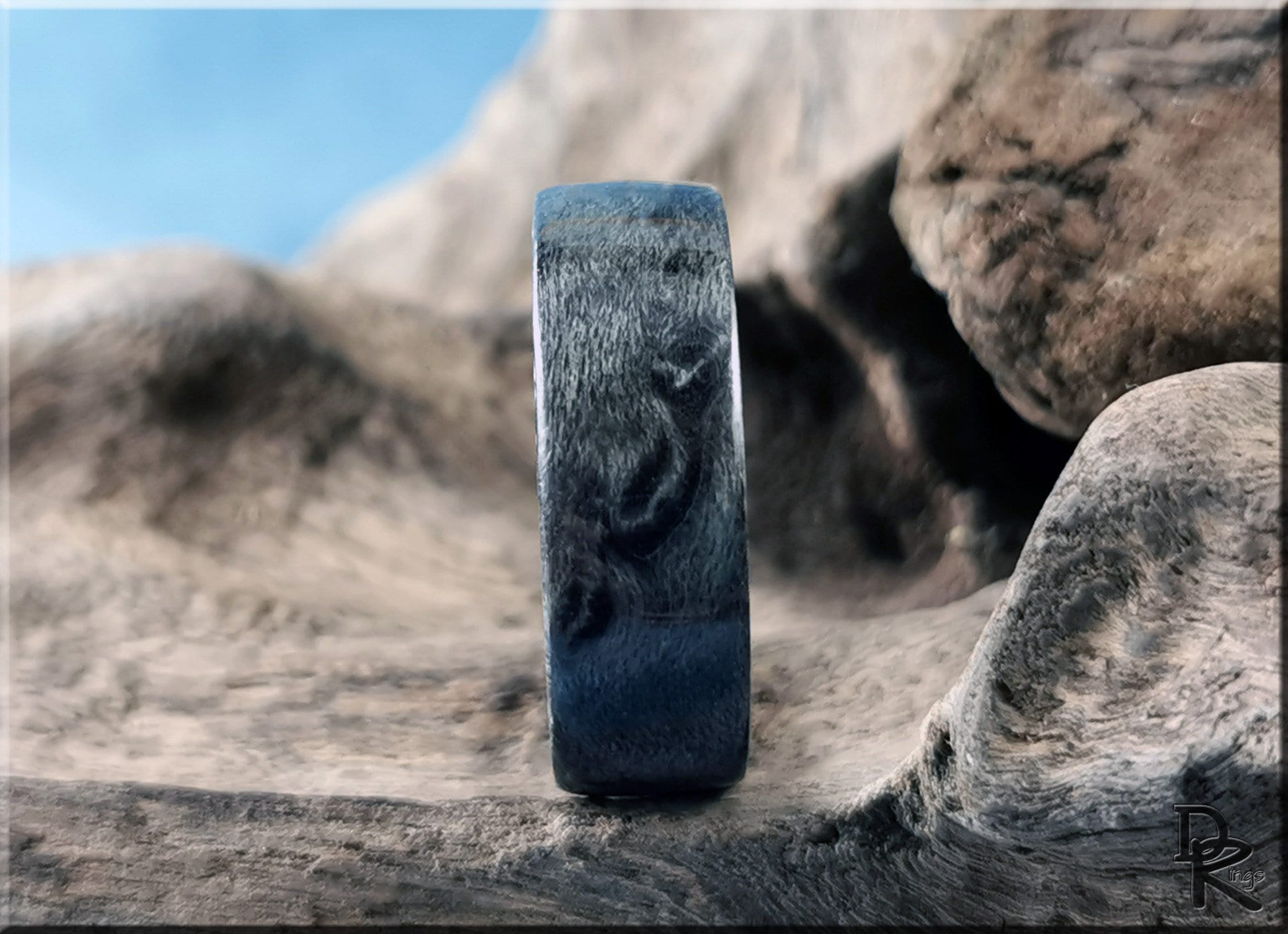 Grey maple ring by DR Rings with smooth finish displayed on natural wood background