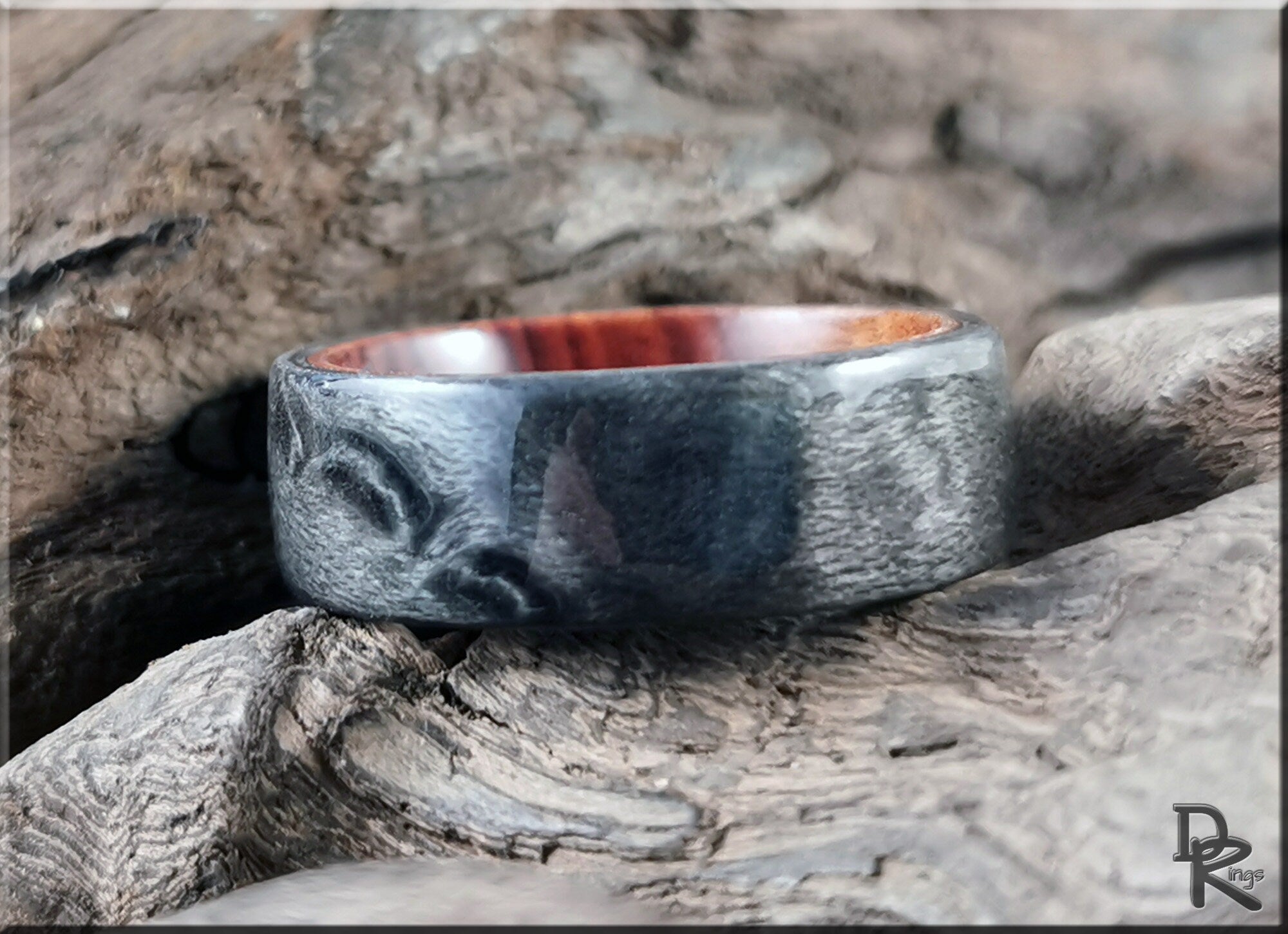DR Rings grey maple ring with smooth textured exterior and polished wooden interior on rustic wood background