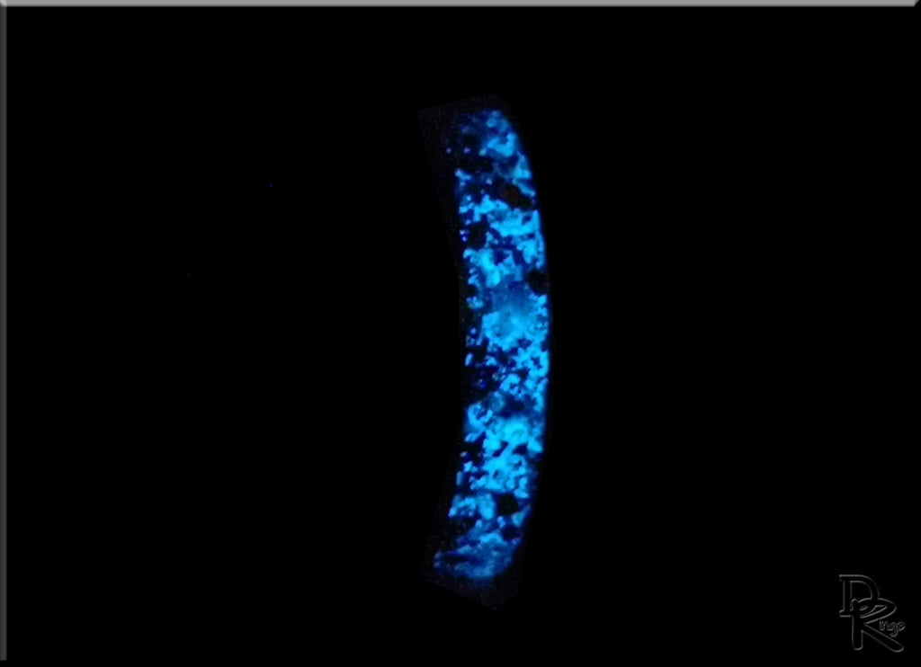 Glowing blue hammered ceramic ring with inlay by DR Rings on a black background