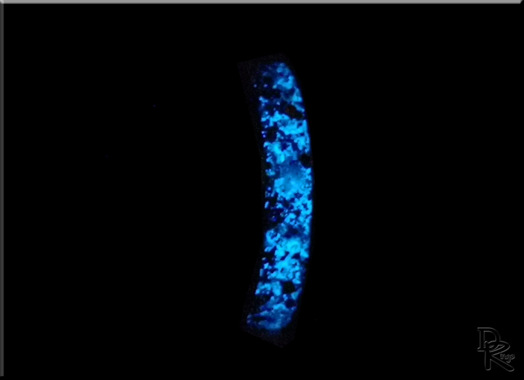 Glowing blue hammered ceramic ring with inlay by DR Rings on a black background