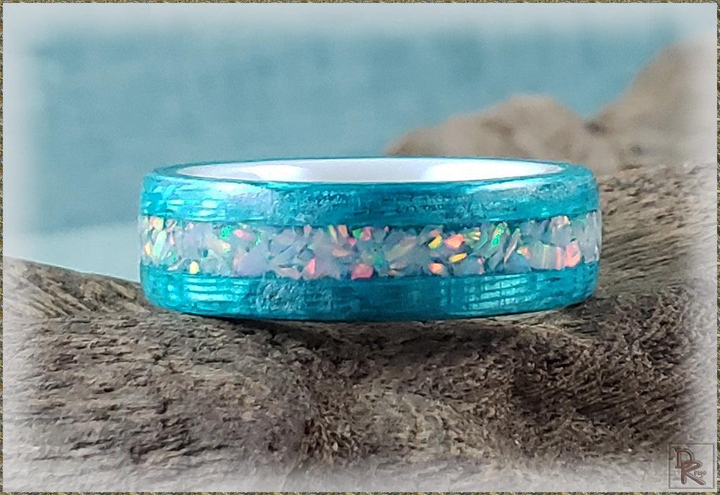 DR Rings blue opal inlay wood ring with iridescent opal details on rustic background