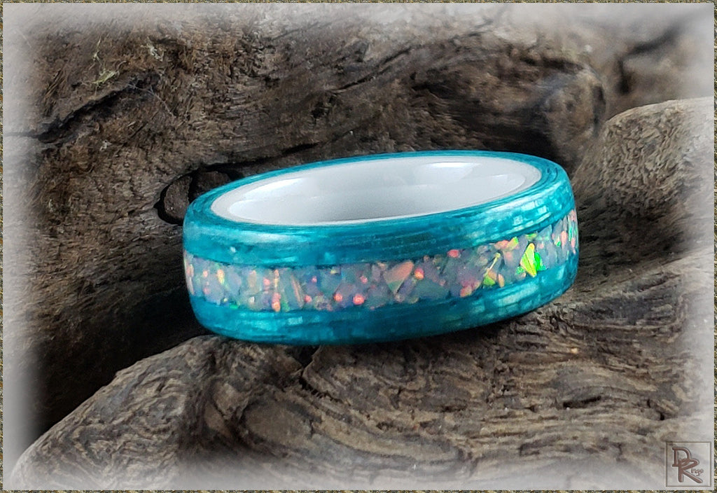 DR Rings opal inlay wood ring with vibrant blue finish and colorful opal inlay on natural wood background