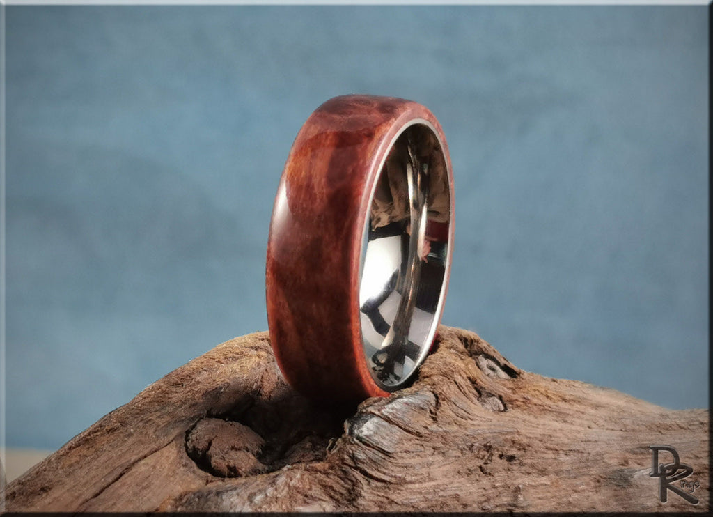 Redwood ring on titanium by DR Rings displayed on rustic wood background