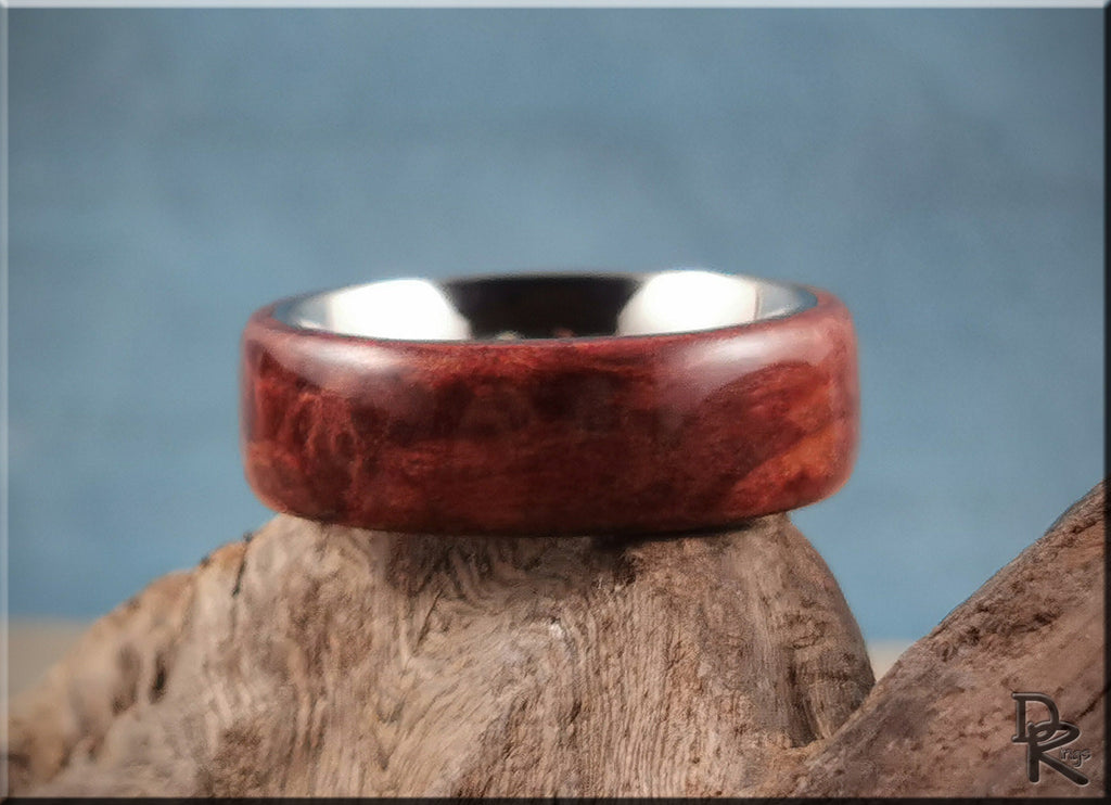 DR Rings redwood ring on titanium with smooth polished wood finish displayed on natural wood