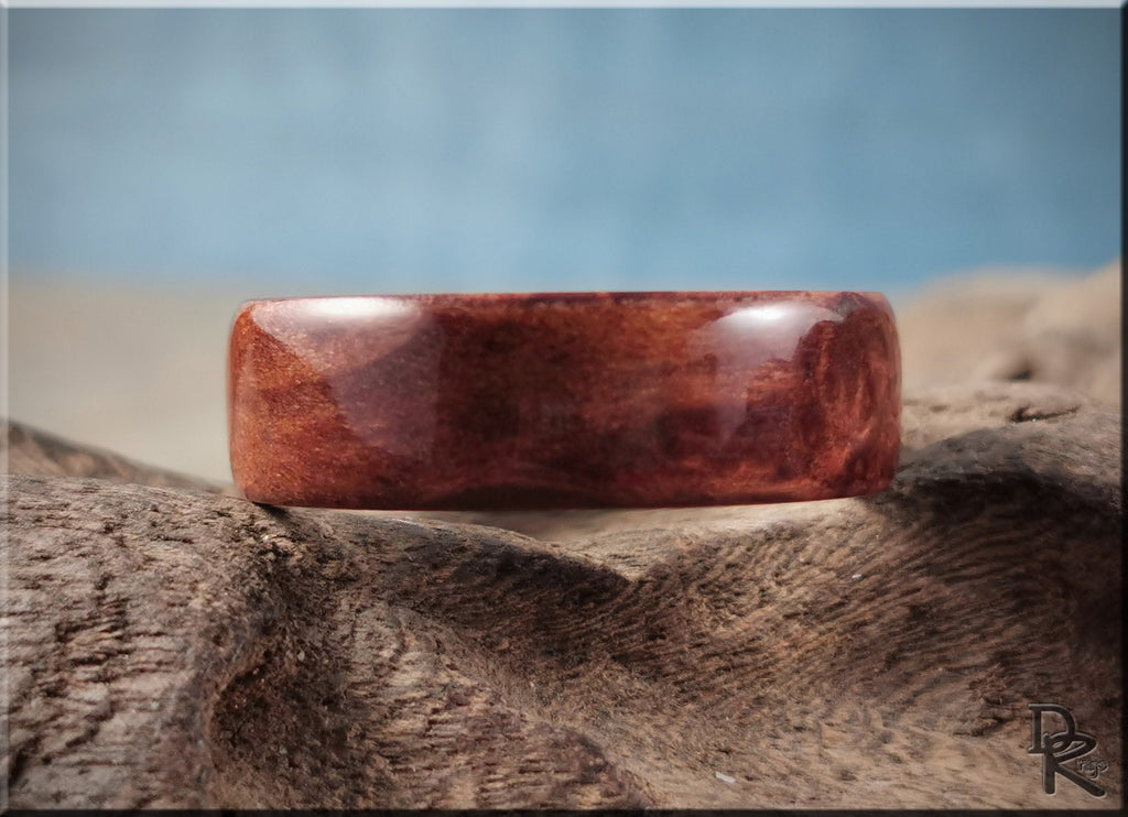 Redwood ring on titanium with rich reddish-brown wood grain and smooth polished finish by DR Rings