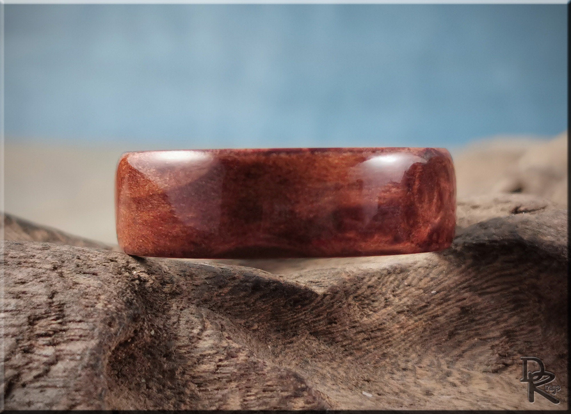 Redwood ring on titanium with rich reddish-brown wood grain and smooth polished finish by DR Rings