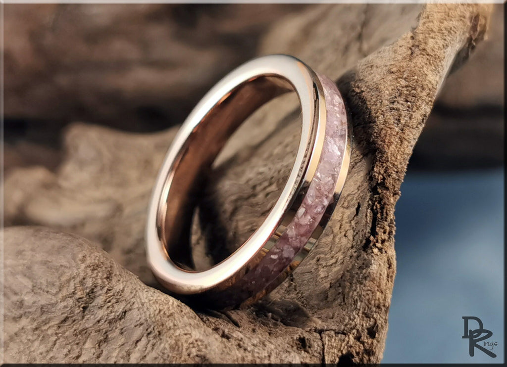 Rose tungsten ring with lepidolite inlay displayed on natural wood background by DR Rings