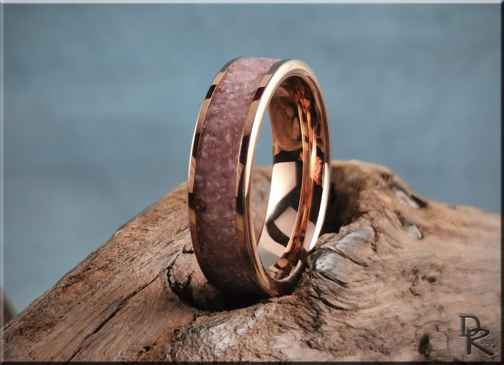 Rose tungsten ring with lepidolite inlay displayed on textured wood background from DR Rings