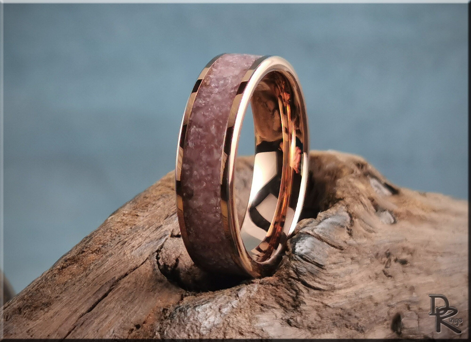 Rose tungsten ring with lepidolite inlay displayed on textured wood background from DR Rings