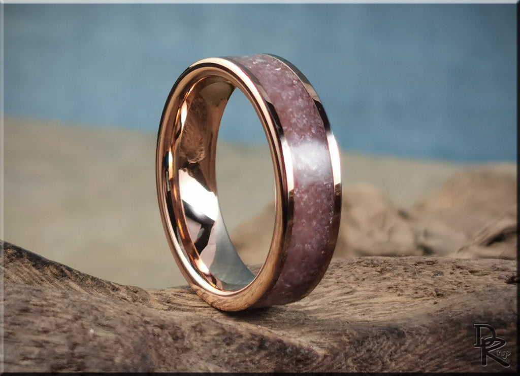 Rose tungsten ring with lepidolite featuring a polished rose gold edge and textured purple stone inlay