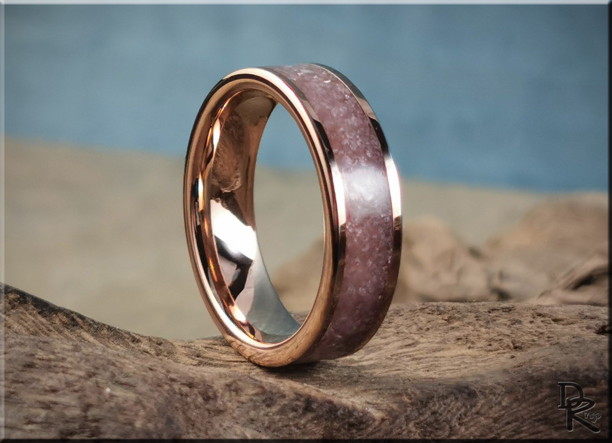 Rose tungsten ring with lepidolite featuring a polished rose gold edge and textured purple stone inlay