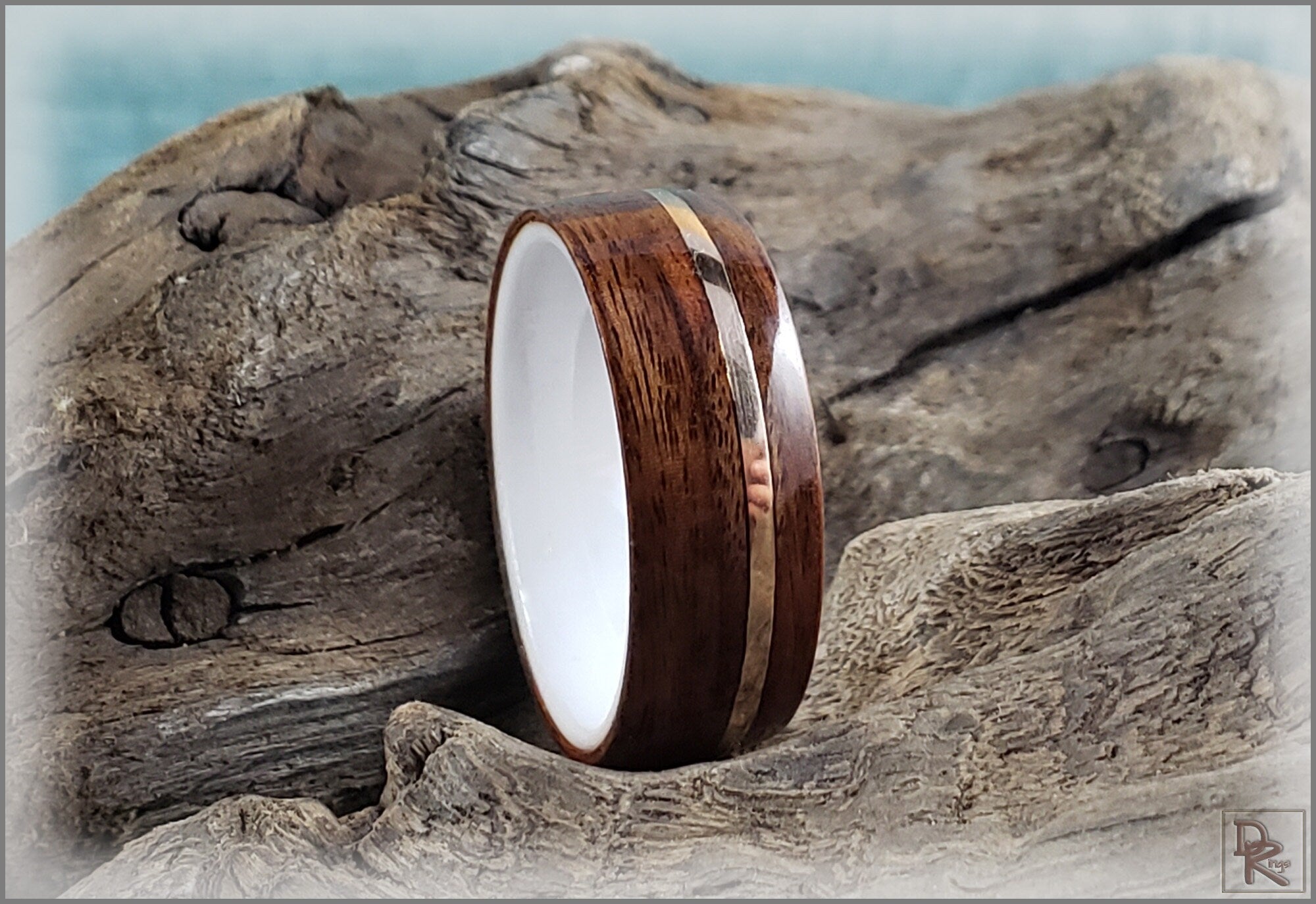 Rosewood ring with wire inlay by DR Rings displayed on textured wood background