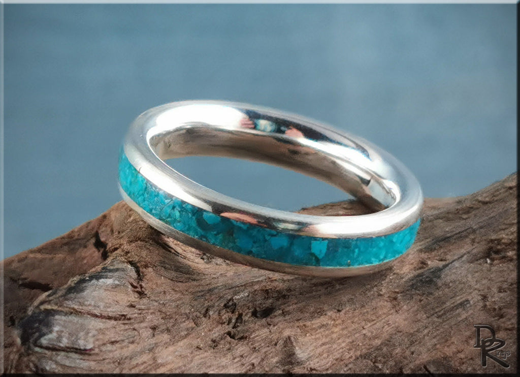 Silver ring with inlay of turquoise stones on rustic wood background by DR Rings