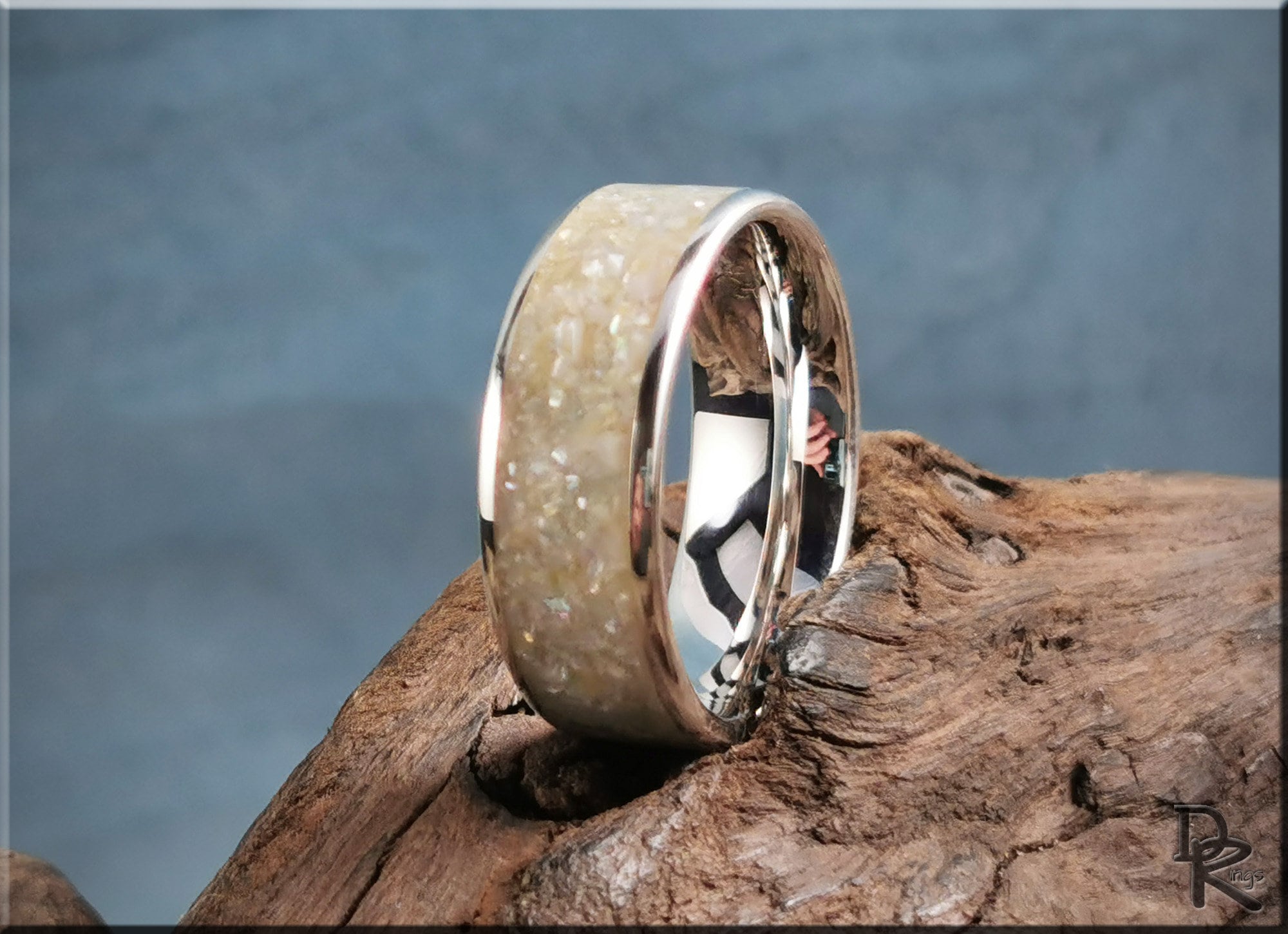 DR Rings sterling silver ring with pearl inlay on rustic wood background