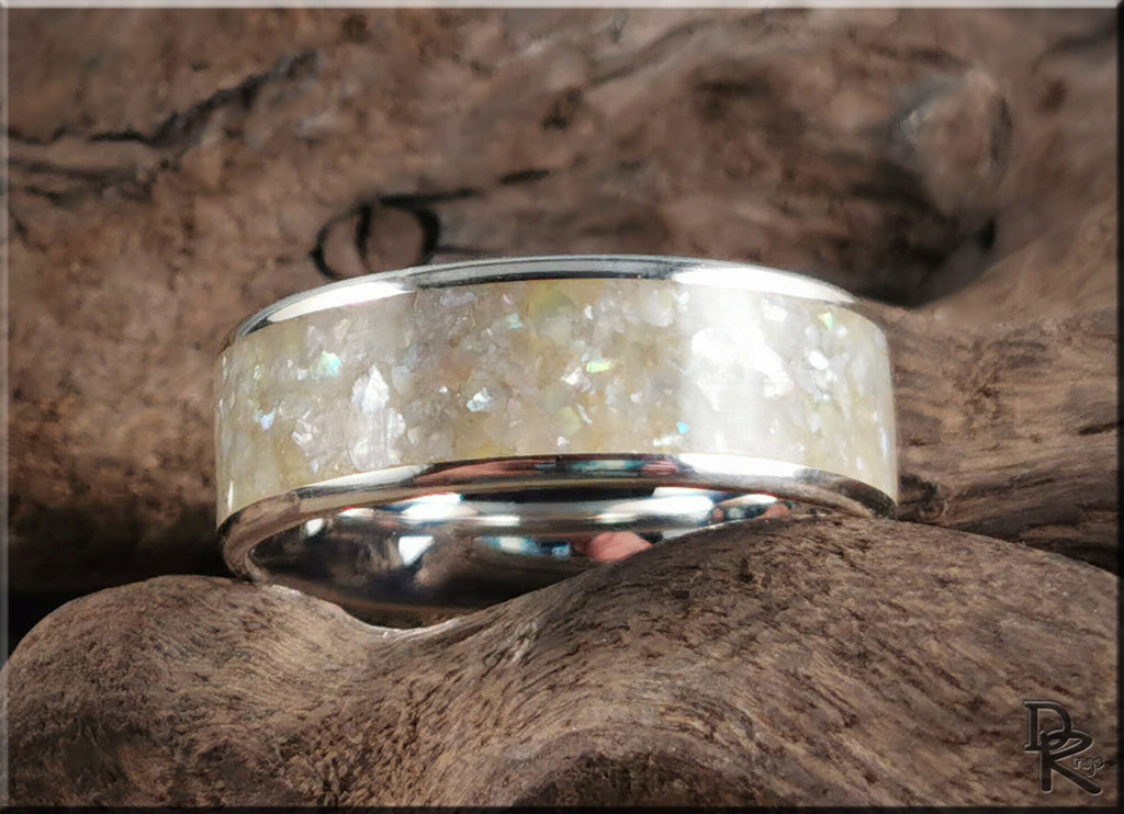 DR Rings sterling silver ring with pearl inlay featuring a polished band on natural wood background