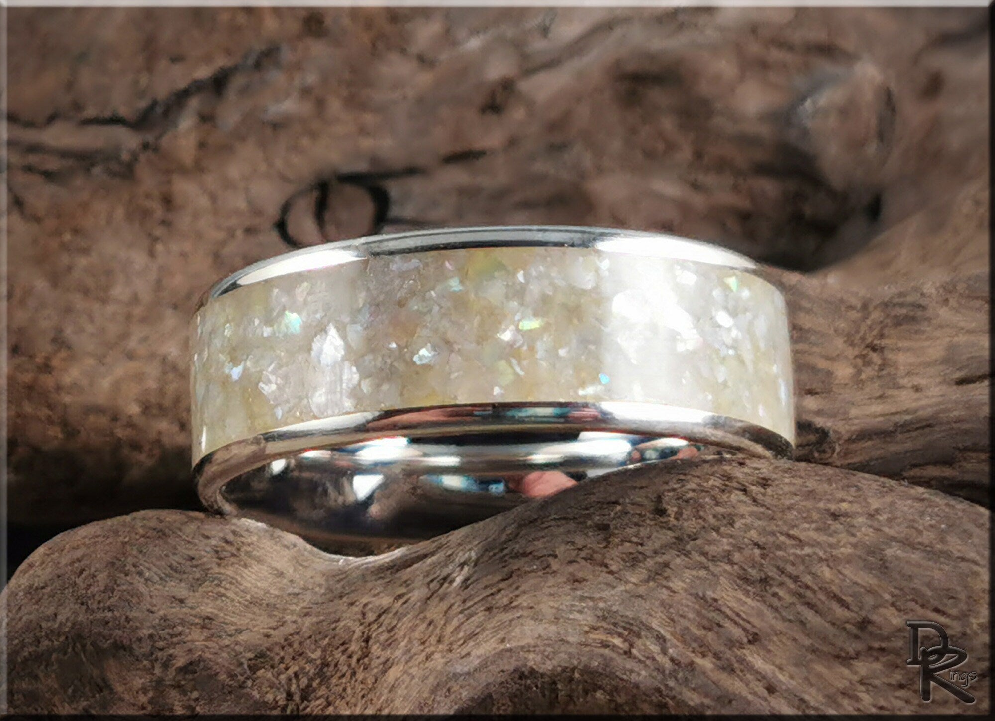 DR Rings sterling silver ring with pearl inlay featuring a polished band on natural wood background