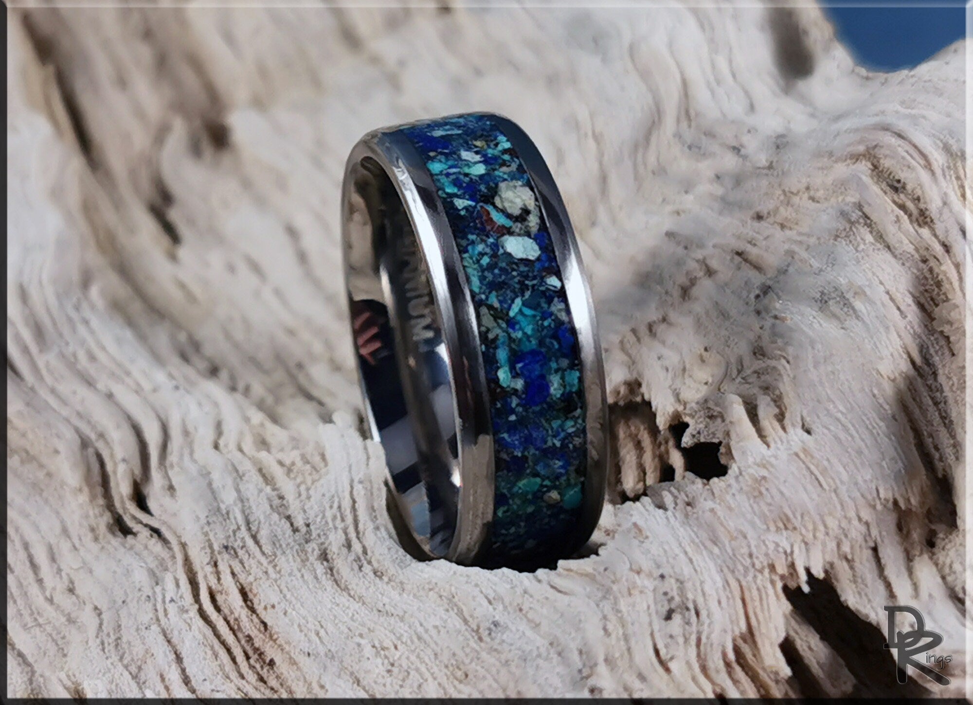 DR Rings titanium ring with azurite inlay displayed on textured wood background