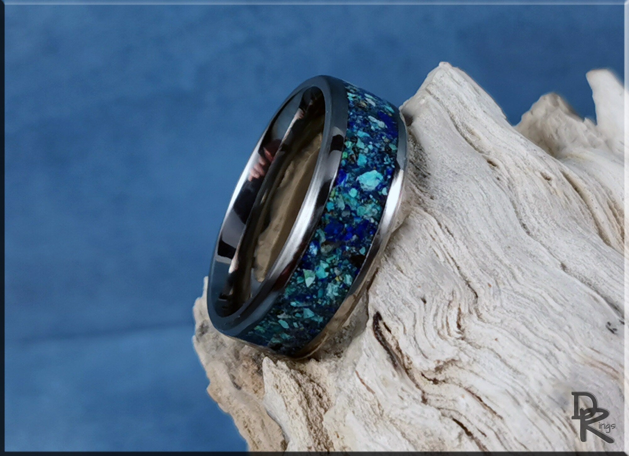 DR Rings titanium ring with azurite blue and green stone inlay on a textured white surface