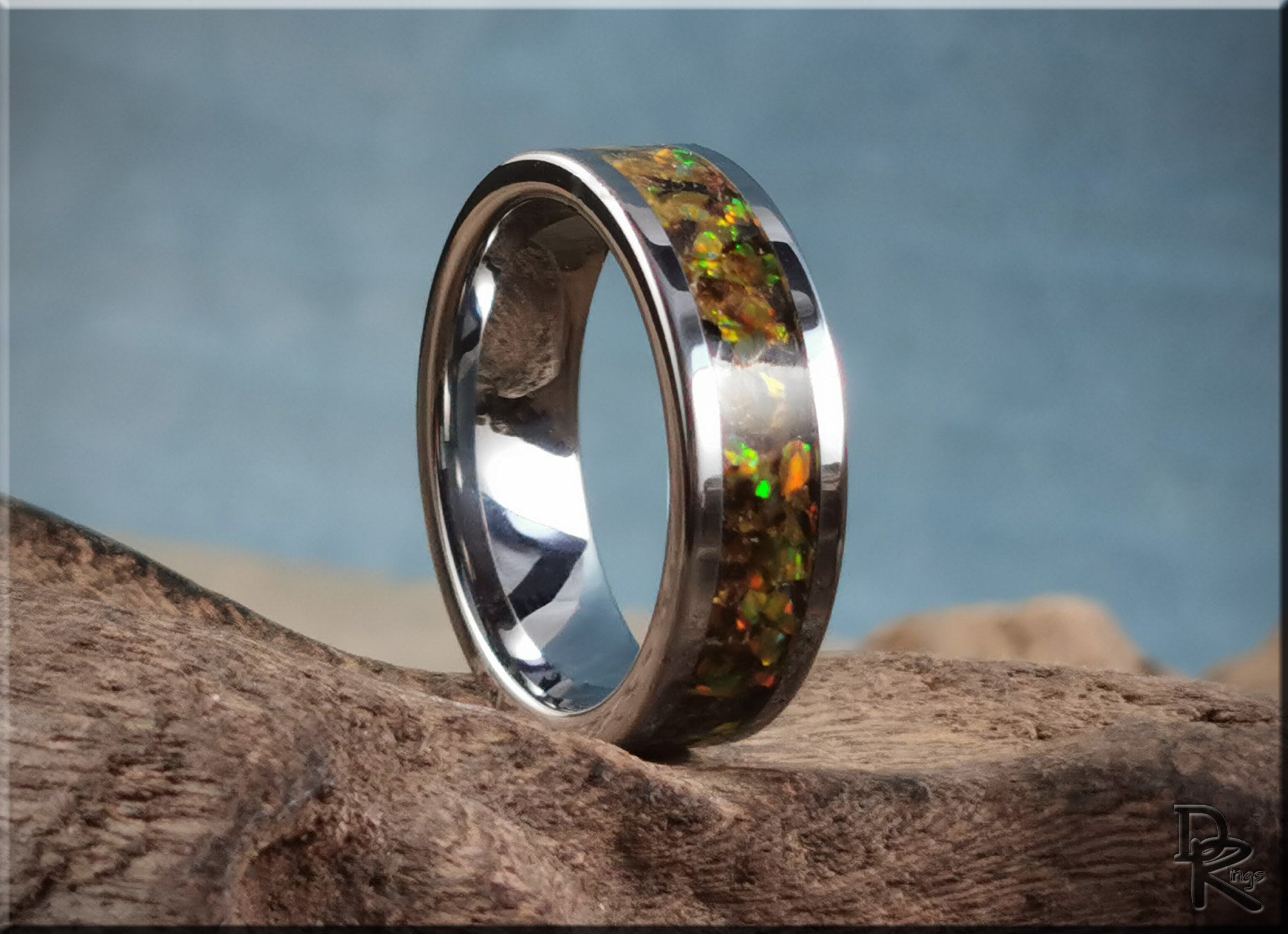 DR Rings titanium ring with inlay featuring a glossy finish and vibrant green and orange accents