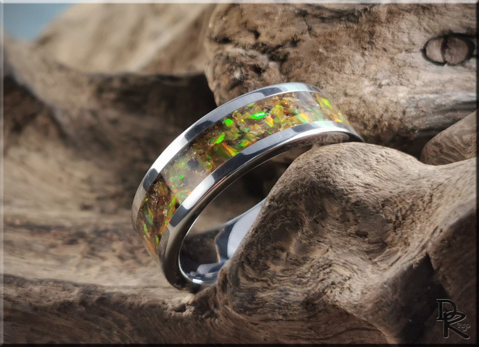 DR Rings titanium ring with inlay featuring a polished silver band and vibrant green and gold opal design
