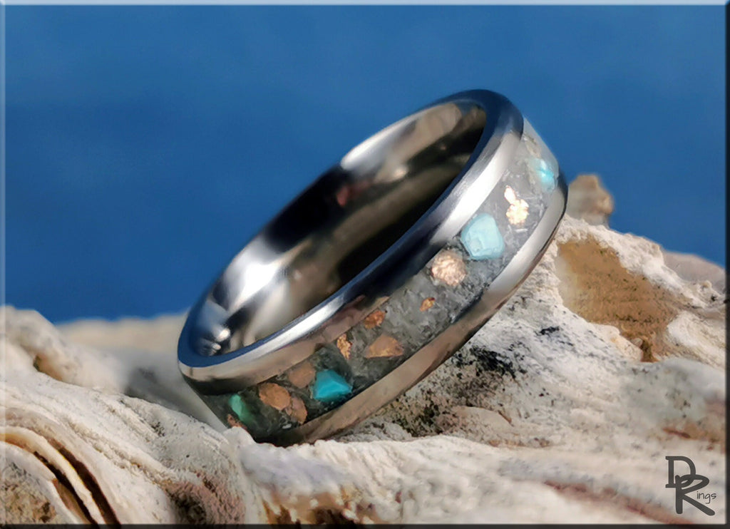 DR Rings titanium ring with inlay featuring blue and metallic stone accents on rustic background