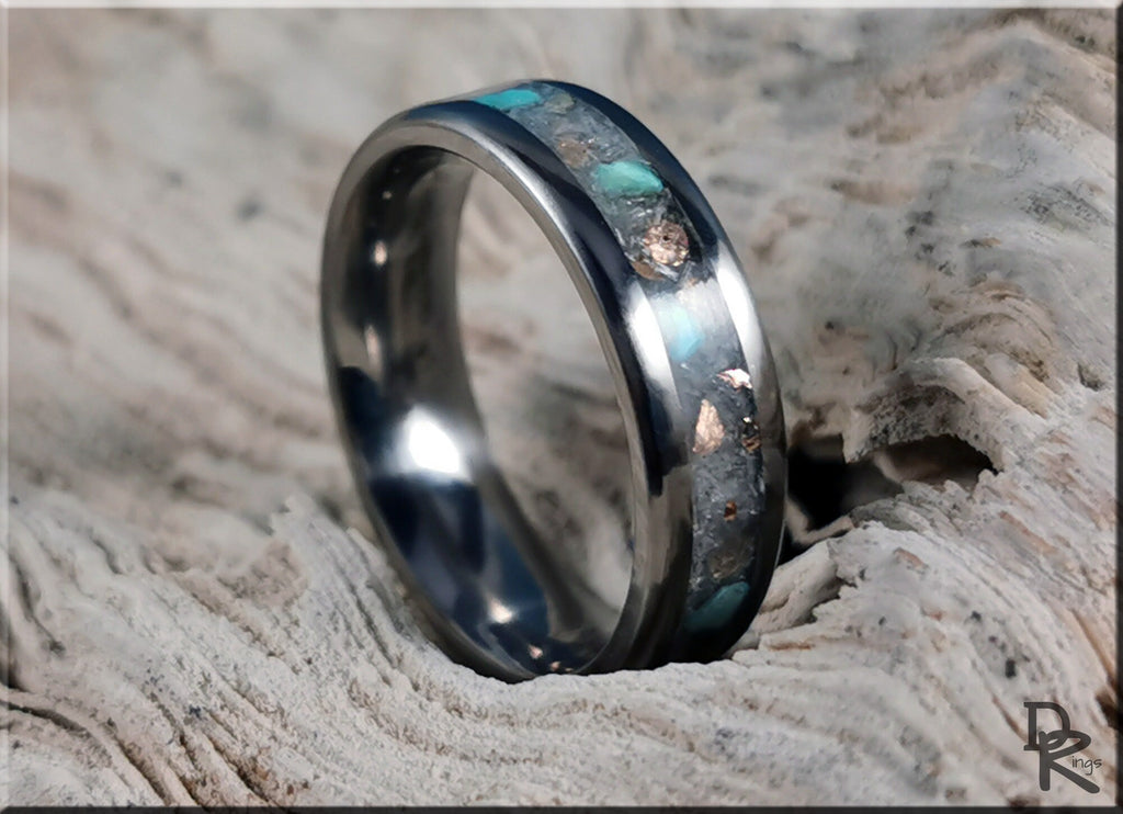 DR Rings titanium ring with inlay featuring turquoise and metallic stone design on textured wood