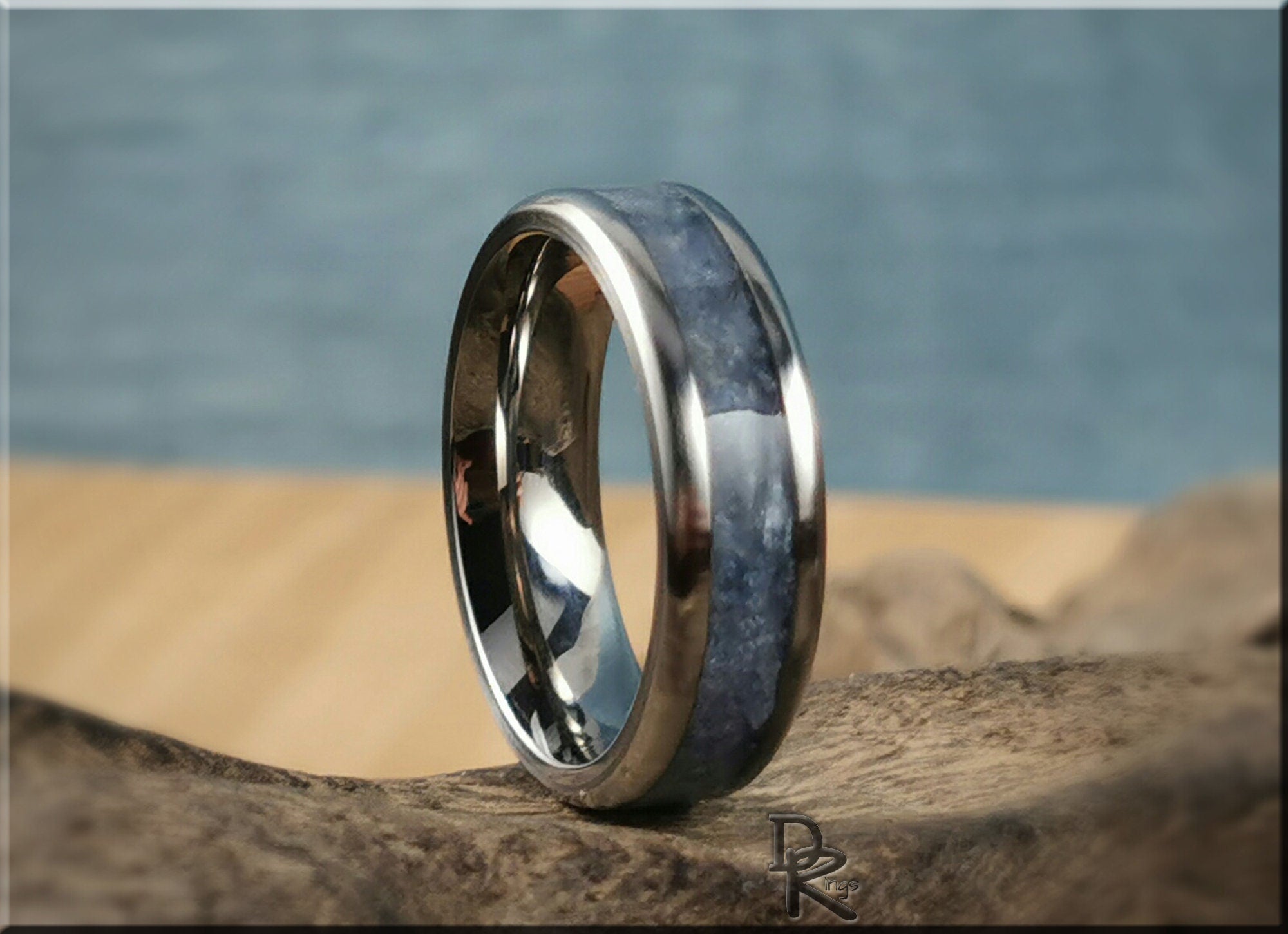 DR Rings titanium ring with kyanite blue stone inlay on a natural wood surface