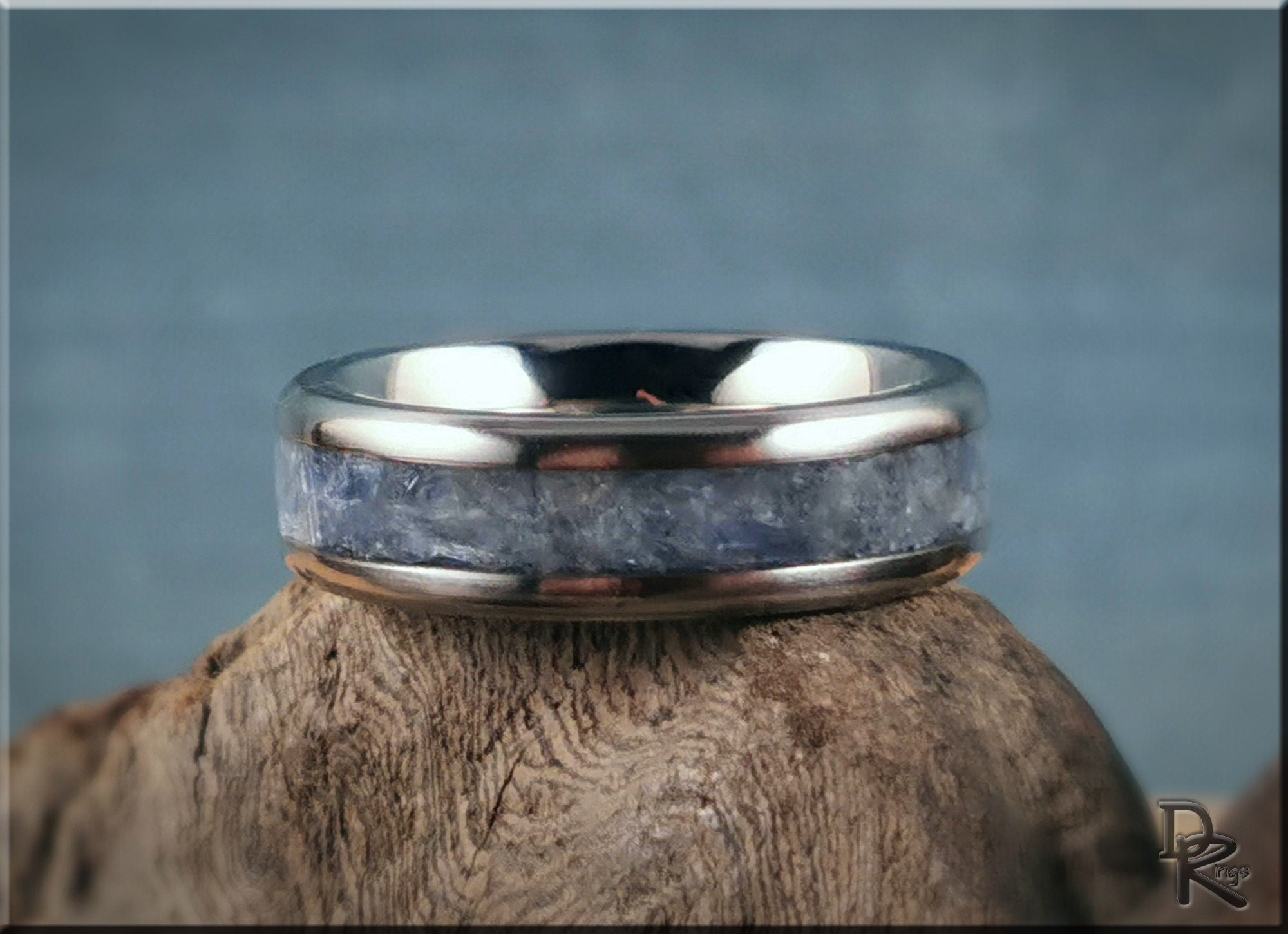 DR Rings titanium ring with kyanite stone inlaid on polished metal band on wooden surface