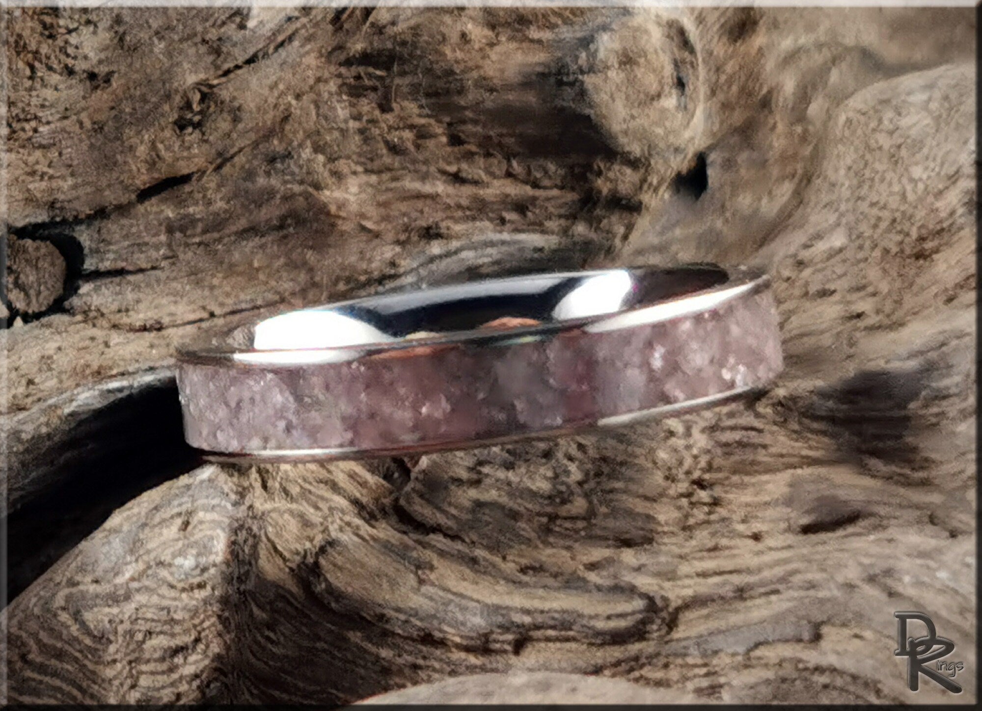 Titanium ring with lepidolite inlay by DR Rings on natural wood background