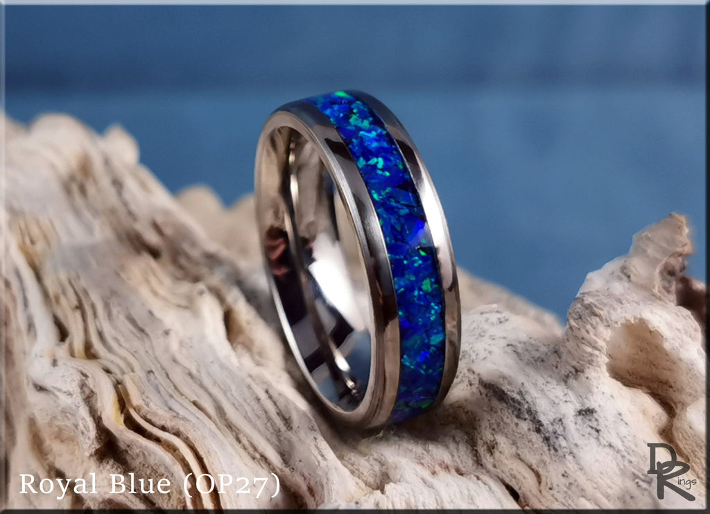DR Rings titanium ring with opal inlay featuring royal blue vibrant colors on natural wood background