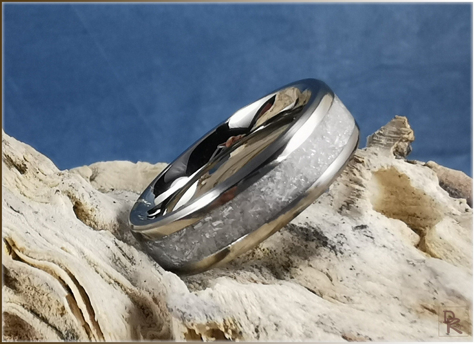 DR Rings titanium ring with selenite featuring a polished metallic band and white selenite inlay on natural stone