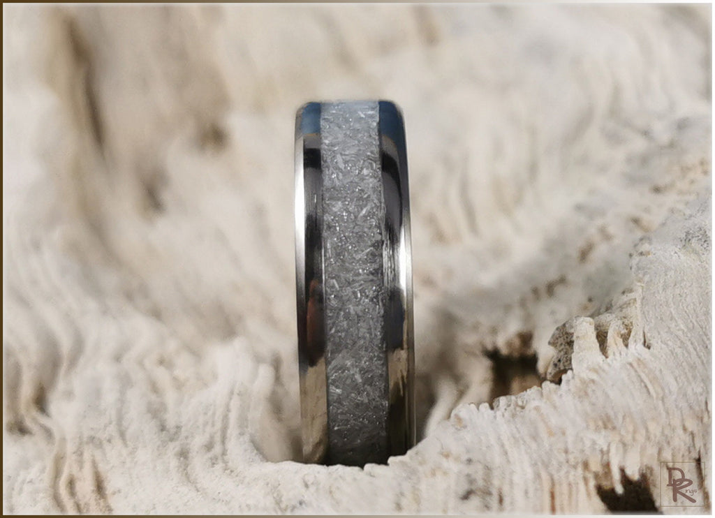 DR Rings titanium ring with selenite center band on textured natural background